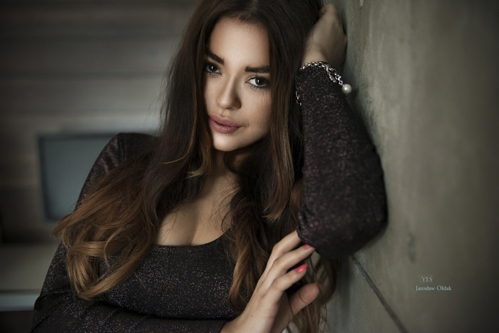 Woman leaning against a wall