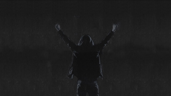 Person in hoodie with arms raised