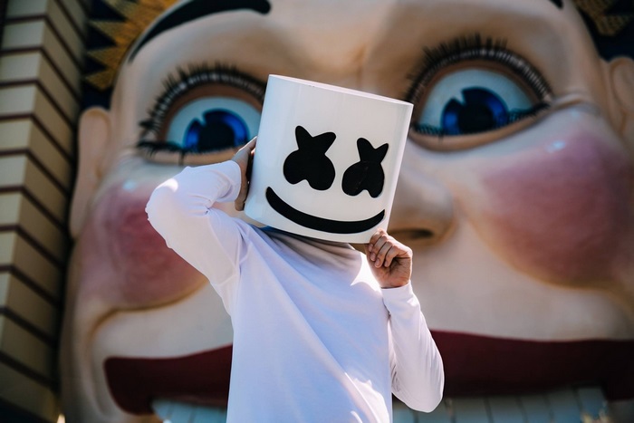 Marshmello in front of a large clown face