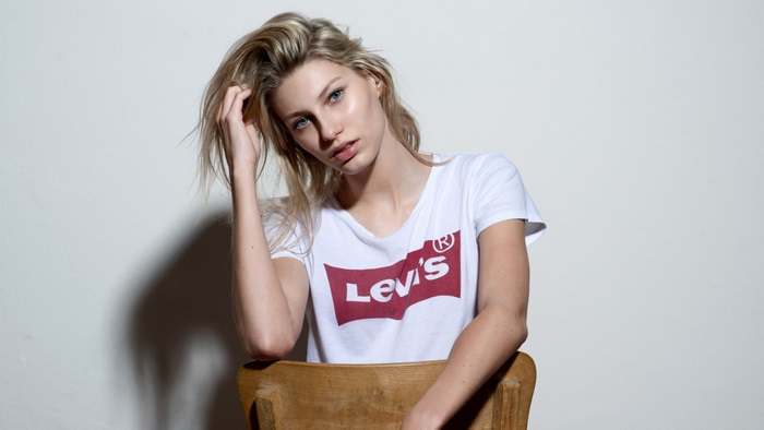 Woman in Levi's T-shirt sitting on chair