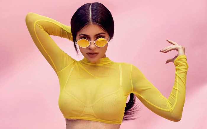 Kylie Jenner in yellow mesh top and sunglasses