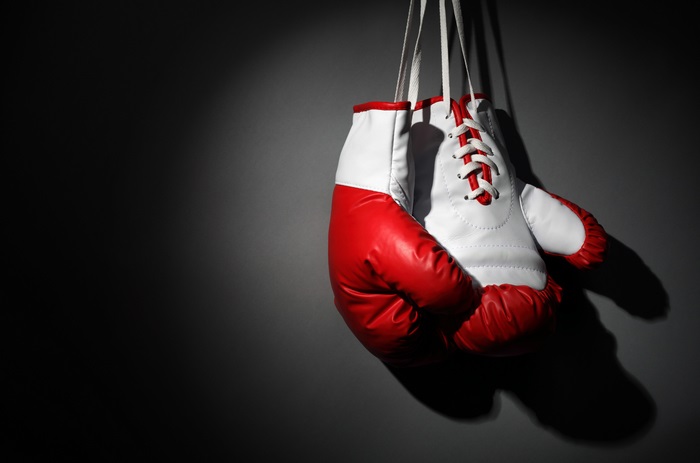 Red and white boxing gloves hanging