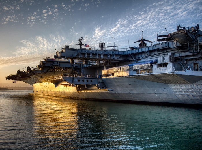 Aircraft carrier in the ocean at sunset 4K
