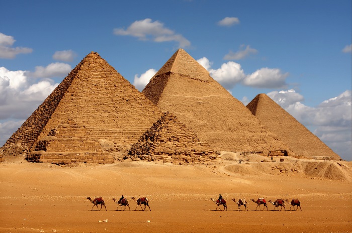 Pyramids of Giza with camels in the desert