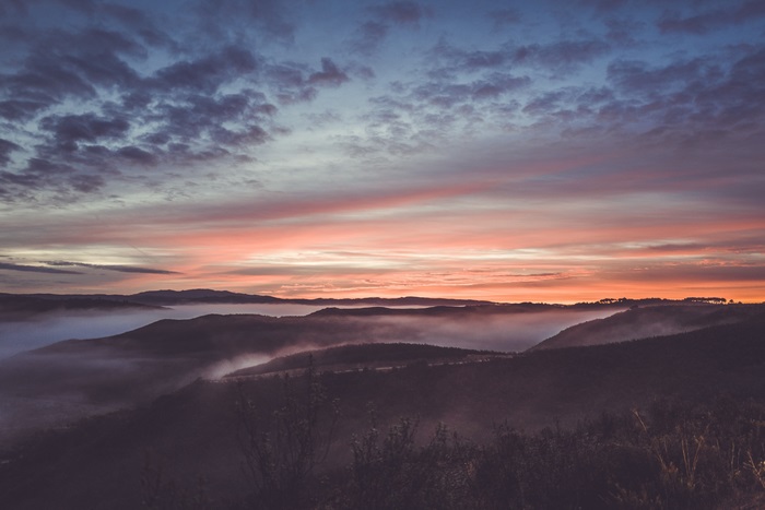 Sunrise over misty mountains with colorful sky