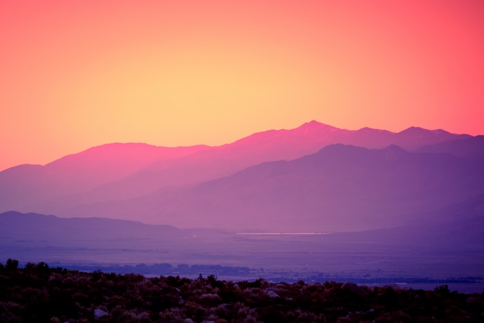 Sunset over layered mountains and desert