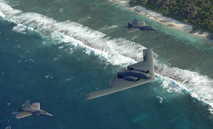 B-2 Spirit Stealth Bomber with F-22 Raptors Over Ocean