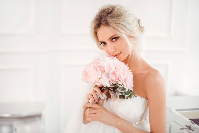 Elegant Bride Holding Pink Flowers 4K