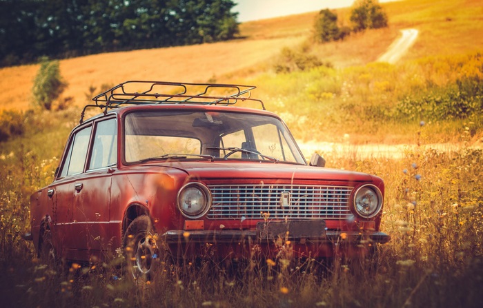 Red Lada car in a field