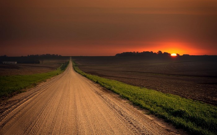 Sunset Over Dirt Road in Open Plains