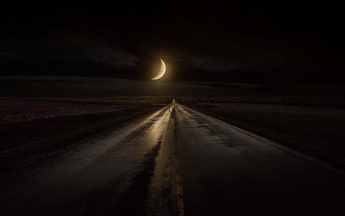Road at Night Under a Crescent Moon