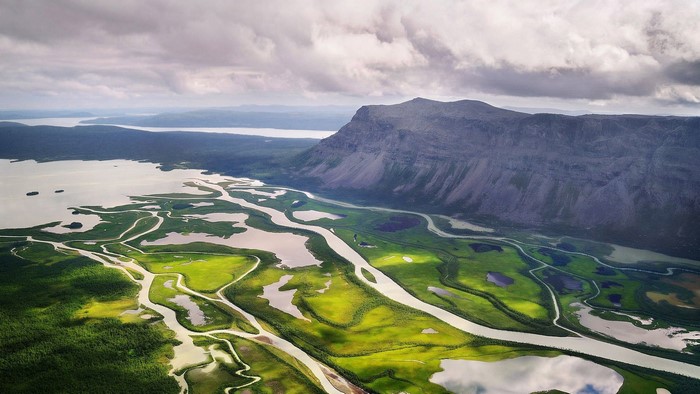 Aerial view of a river delta and mountain in Sweden