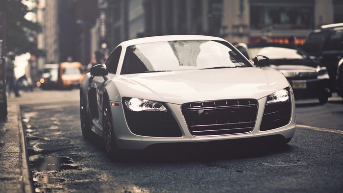 White Audi R8 parked on a wet city street