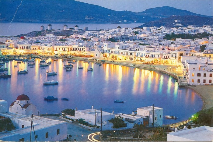 Mykonos, Greece harbor with windmills at dusk
