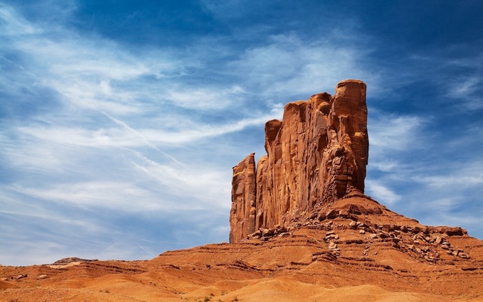 Monument Valley rock formation under a blue sky
