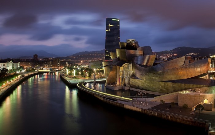 Guggenheim Museum Bilbao at night with river and city