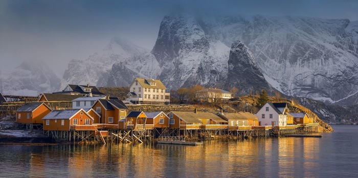 Norwegian village with snowy mountains and sea