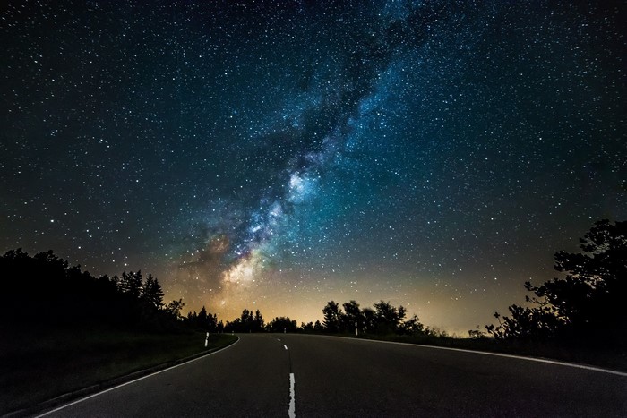 Milky Way over a road at night