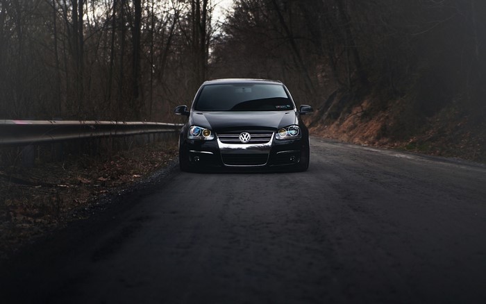 Black Volkswagen Golf MK5 on a road