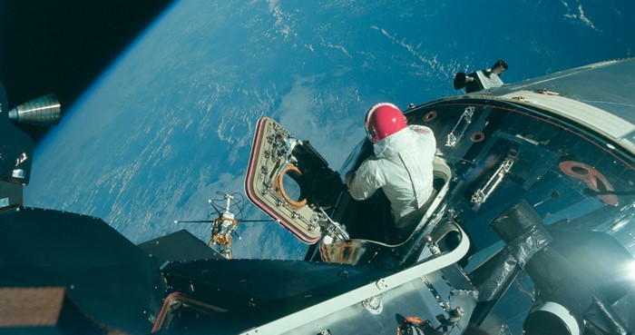 Astronaut in Apollo spacecraft with Earth in background