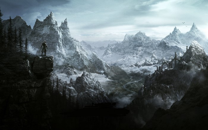 Man overlooking snowy mountains in The Elder Scrolls V Skyrim