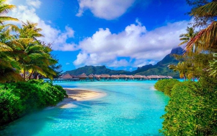 Tropical resort with overwater bungalows and mountains