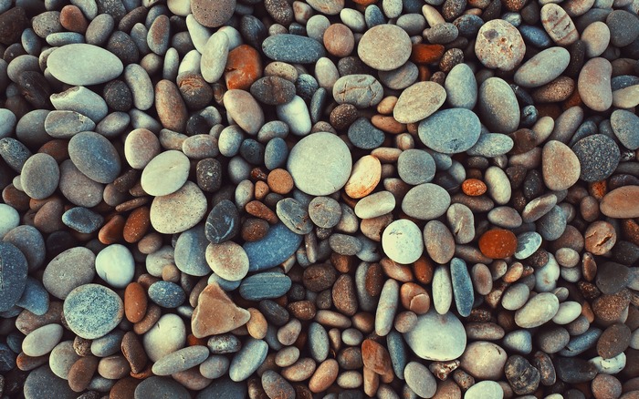 A pile of smooth, colorful pebbles and stones