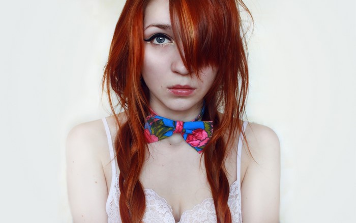Redhead woman with pigtails and floral bow tie