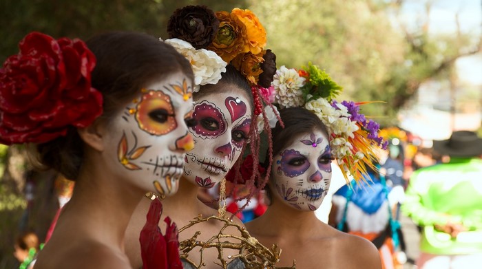 Women with Day of the Dead makeup and flower crowns
