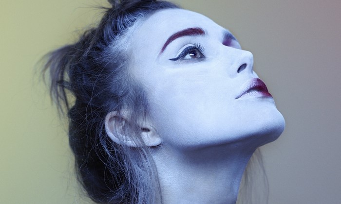 Woman with dramatic makeup looking up