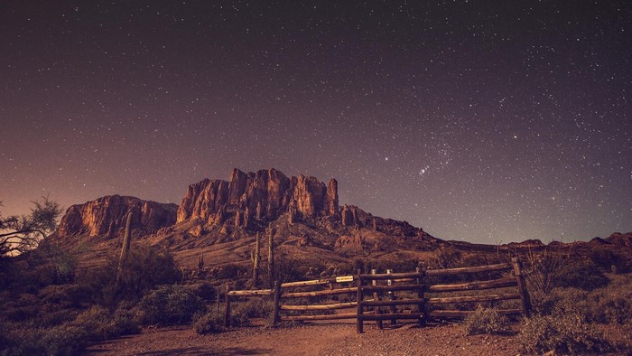 Desert mountains under a starry night sky