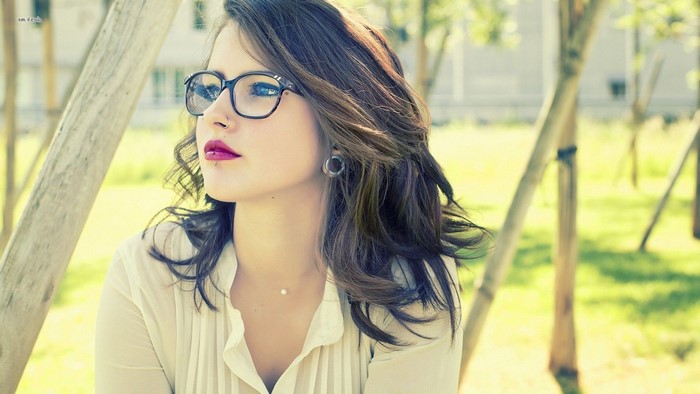 Woman with glasses and piercings outdoors