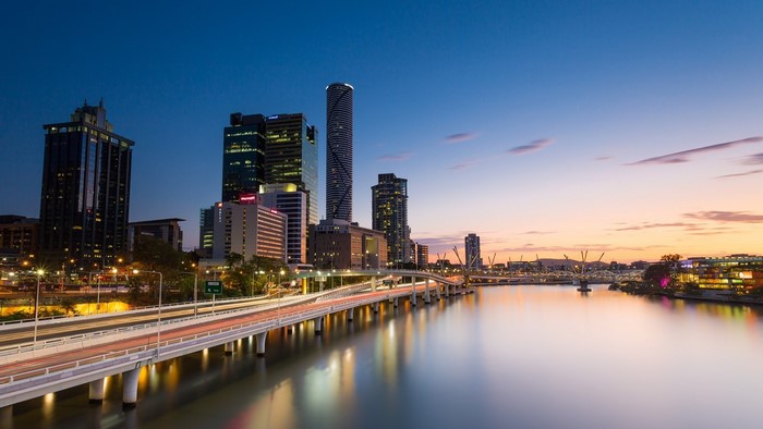 Brisbane cityscape with river and bridge at sunset