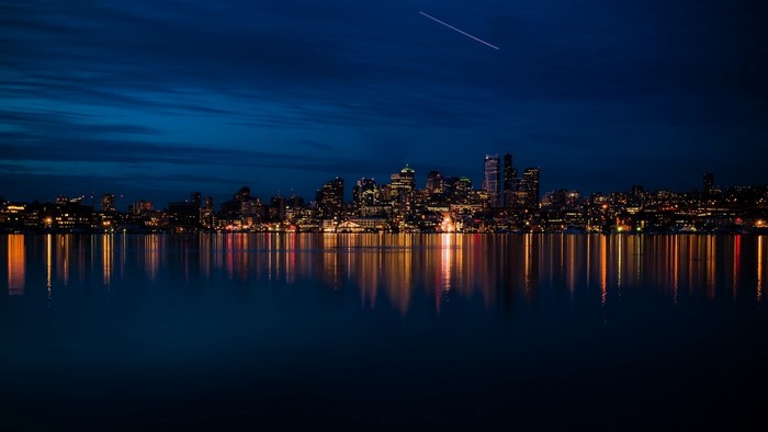 City skyline reflected in water at night