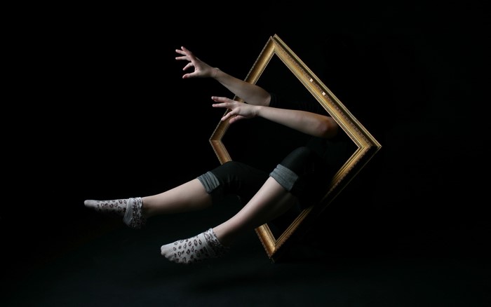Person emerging from a picture frame