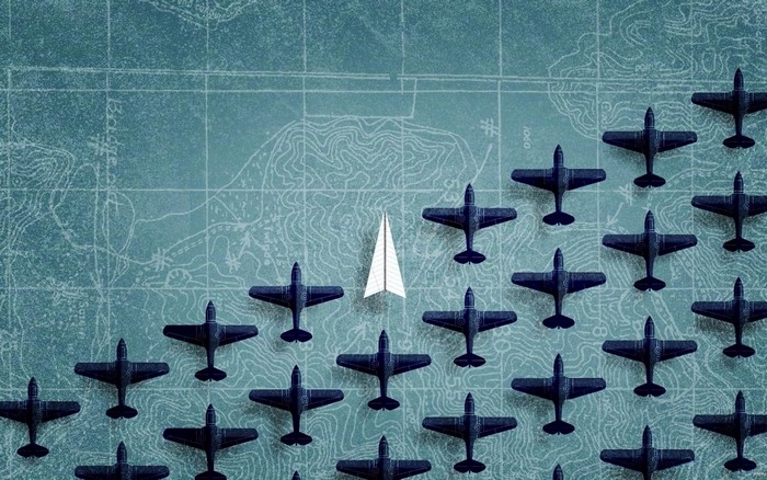Paper airplane leading a formation of dark airplanes over a map