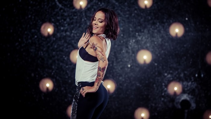 Alizee dancing in front of lights