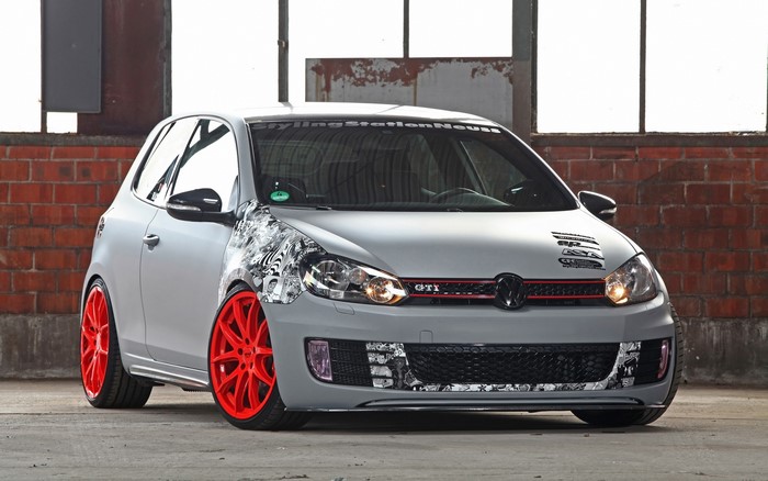 Customized Volkswagen Golf GTI with red wheels