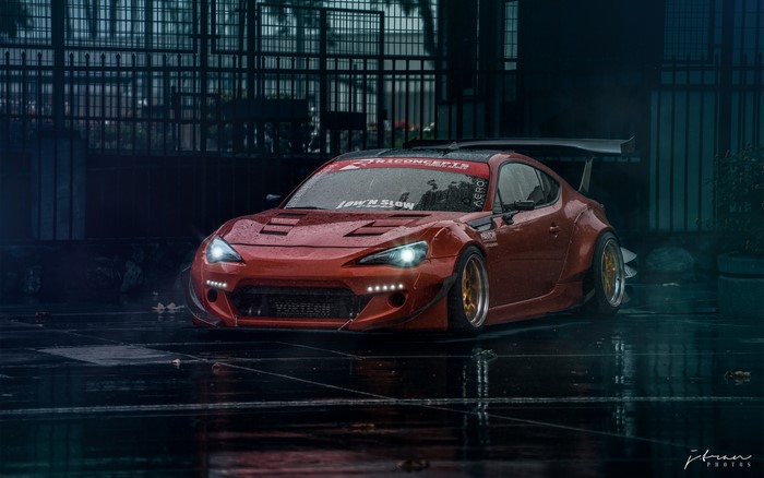 Red Subaru BRZ with large spoiler in rain