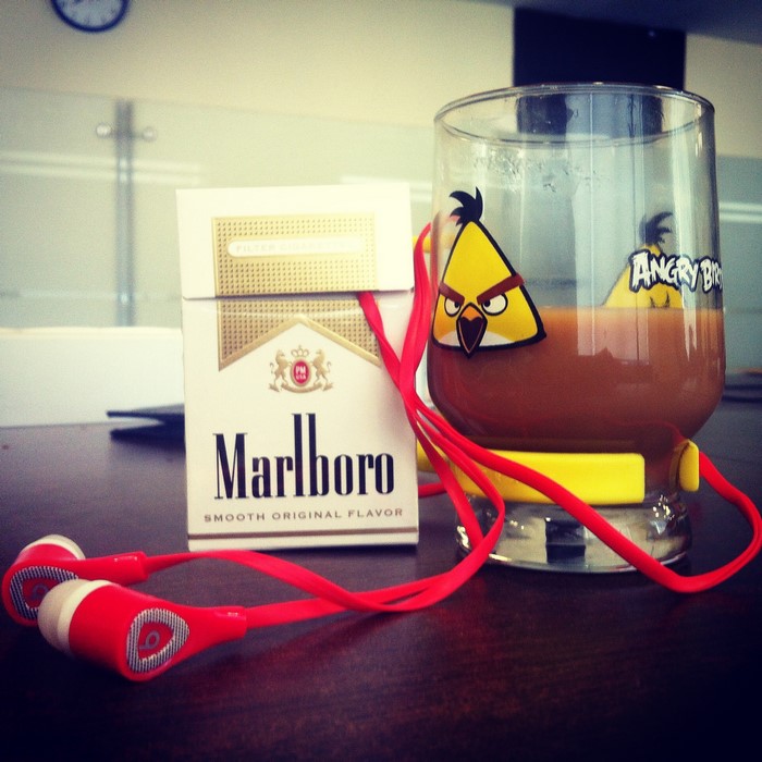 Marlboro cigarettes, Angry Birds glass, and headphones
