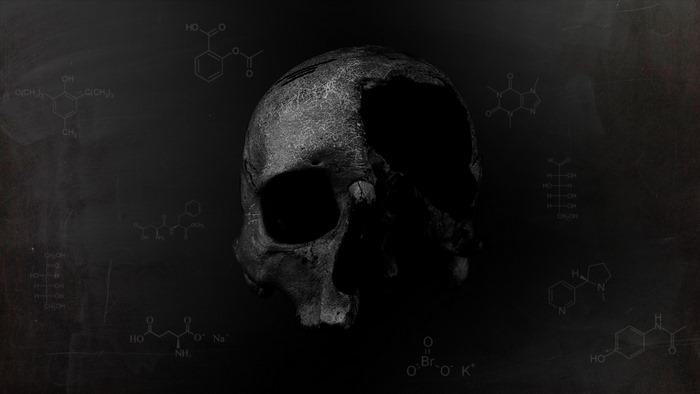 Skull with chemical formulas on dark background