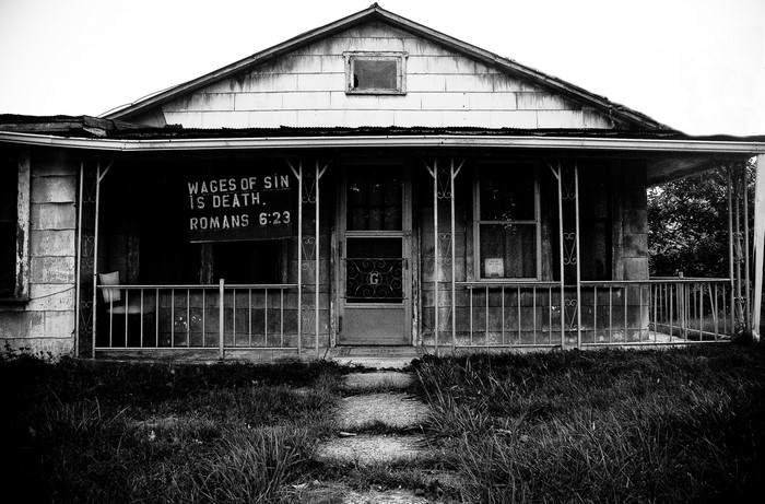 Abandoned house with religious sign