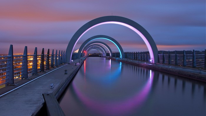 The Falkirk Wheel canal lock at dusk with colorful lights