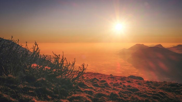 Sunset over mountains with lens flare