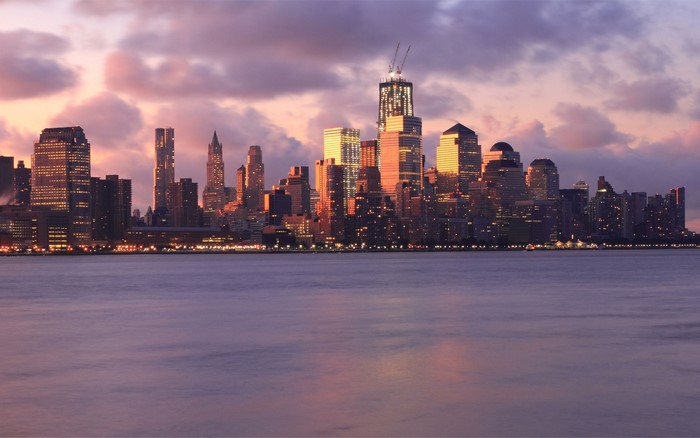 New York City skyline at sunset over the bay