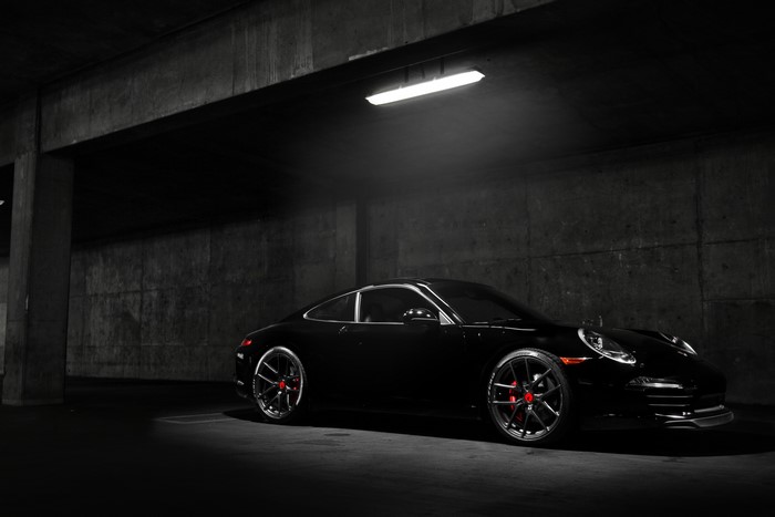 Black Porsche 911 Carrera S in Dimly Lit Garage