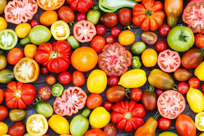Assortment of colorful heirloom tomatoes on a wooden surface
