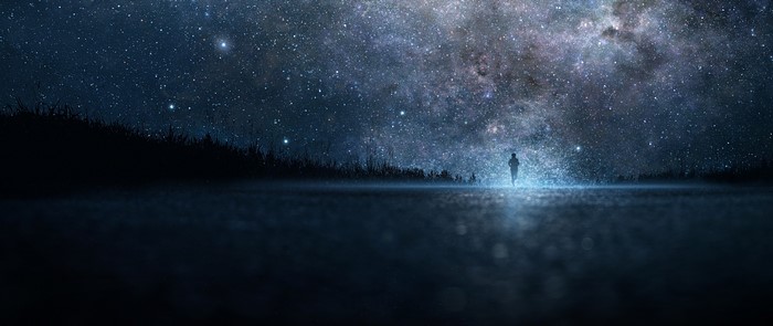 Silhouette of a person under a starry night sky