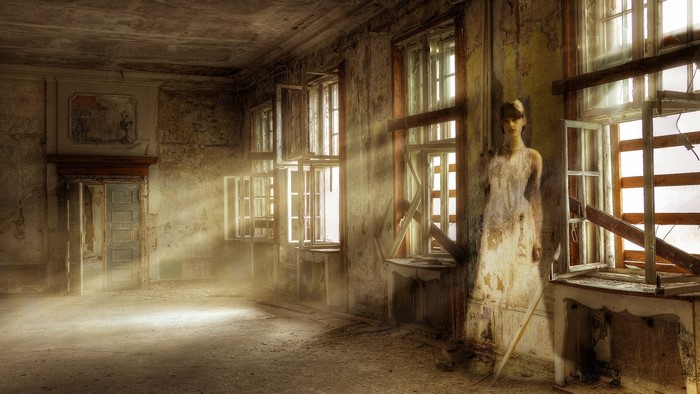 Abandoned room with mannequin and sun rays