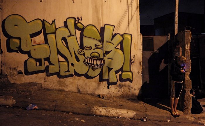 Graffiti on a wall in a city street at night